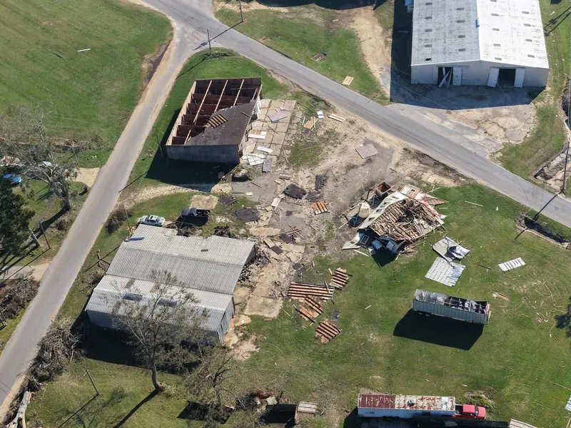 Wind-damaged buildings and scattered debris from above